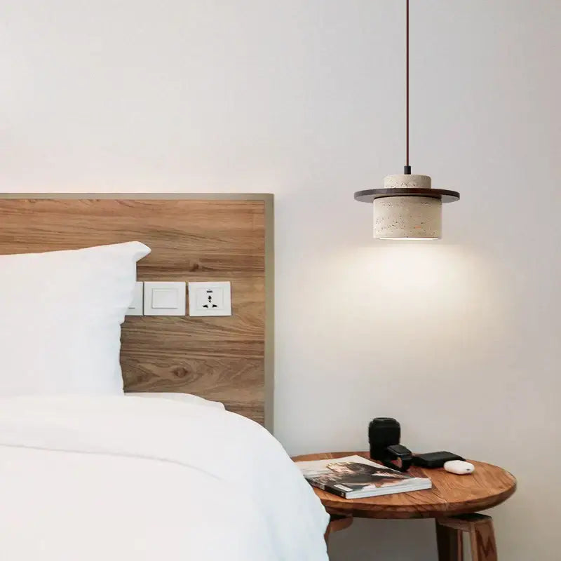 Minimalist pendant lamp with off-white concrete body and dark wood accents in decorbites led yellow travertine style