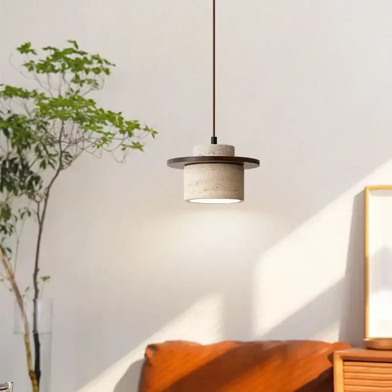 Concrete pendant lamp with matte finish and dark metal accents in minimalist decorbites led yellow travertine style