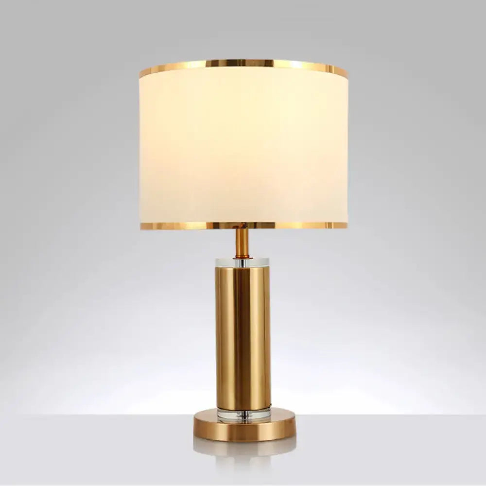 Decorbites minimalist fabric cylinder table lamp with gold-finished brass nightstand base and off-white drum shade