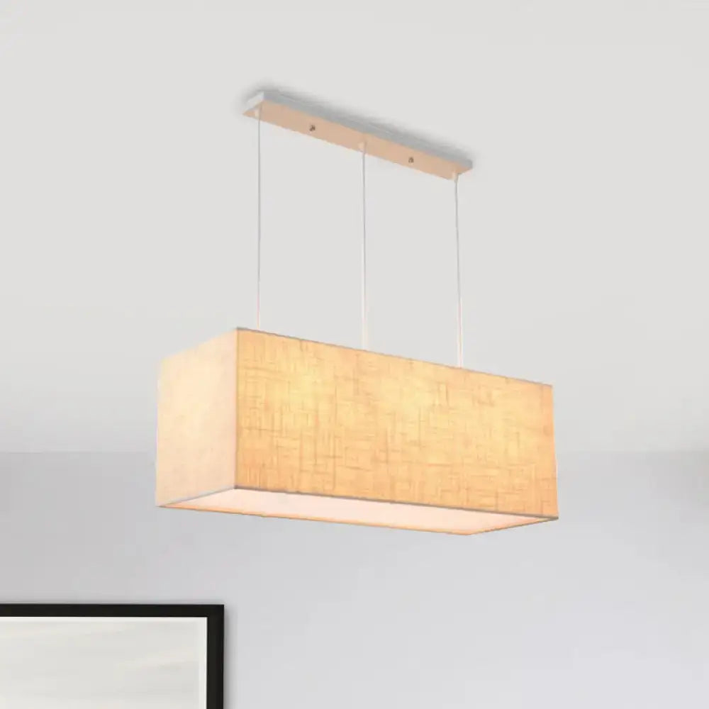 Rectangular fabric pendant light with warm beige shade and wooden mount for minimalist rectangle island lighting fixture