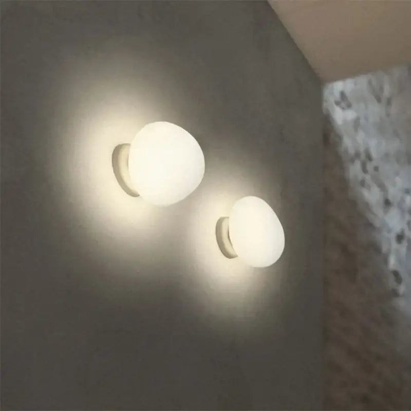 Two minimalist frosted glass globe wall lamps with sleek metallic bases decorbites cobblestone wall lamp for living room