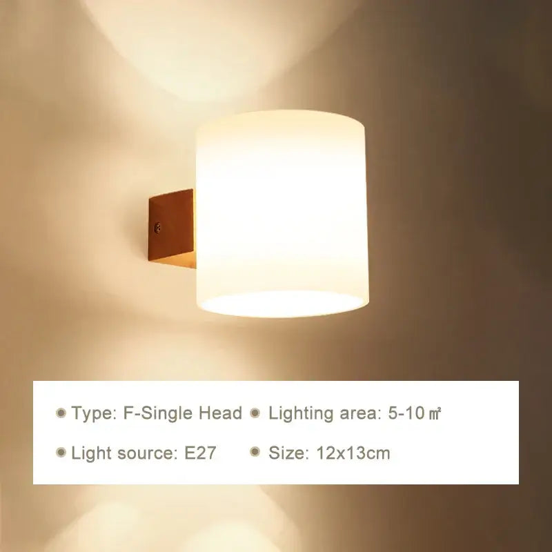 Minimalist warm-toned wooden wall lamp with frosted glass shade and bronze bracket for bedroom with pull chain