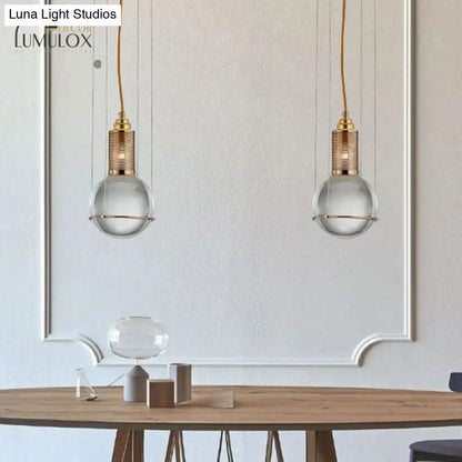 Two elegant decorbites™ hanging lamps with crystal shade and gold-toned brass finish for living room lighting