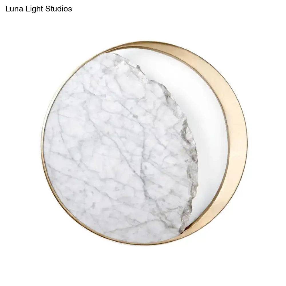 Minimalist gold and white moon wall lamp with a circular frame and marble surface ideal as a wall lamp for living rooms