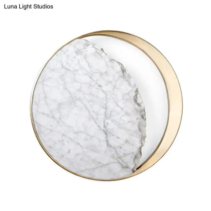 Minimalist gold and white moon wall lamp with a circular frame and marble surface ideal as a wall lamp for living rooms