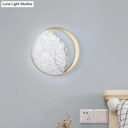 Minimalist gold and white moon wall lamp with a circular marble textured face for living room wall lamp decor