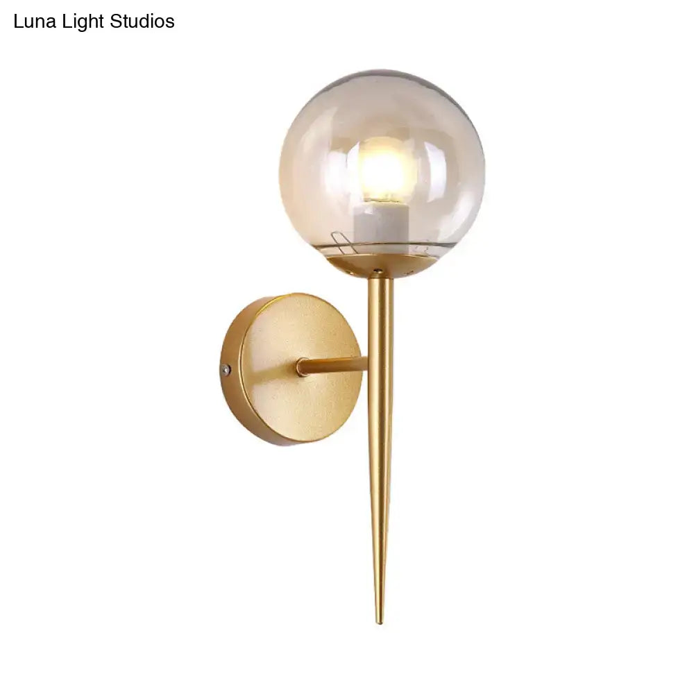 Minimalist gold spherical clear glass wall sconce with pencil arm and e26 e27 bulb fitting for living room use