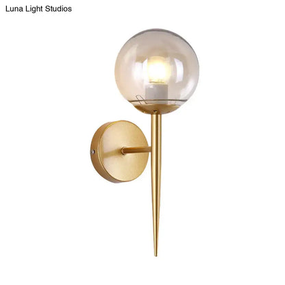 Minimalist gold spherical clear glass wall sconce with pencil arm and e26 e27 bulb fitting for living room use