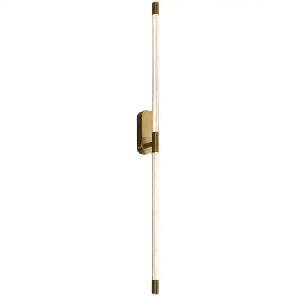A sleek minimalist gold and black decorbites acrylic line led wall light with clear acrylic and brass accents for bedrooms