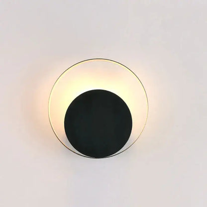 Minimalist gold and black led wall lamp with a circular design for modern living room use