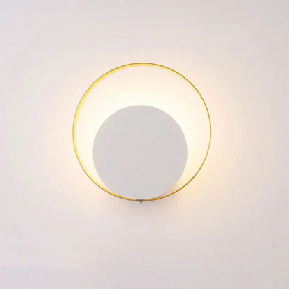 Minimalist gold and black led wall lamp with a circular metal frame and soft white light for living room use
