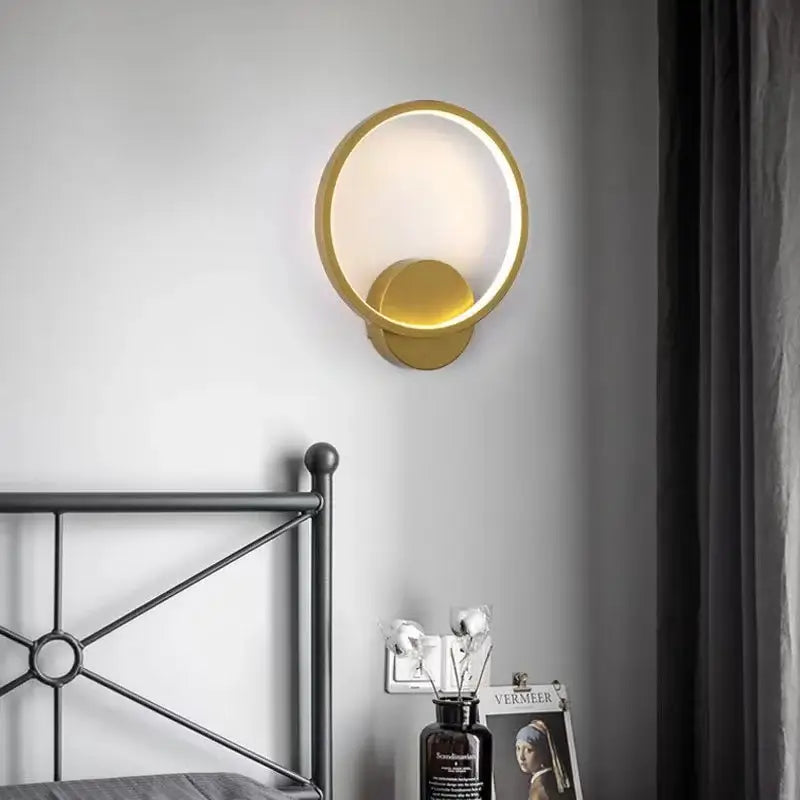 Minimalist gold circular led wall lights featuring a glowing inner ring and smaller disc for bedroom decorbites led wall lights