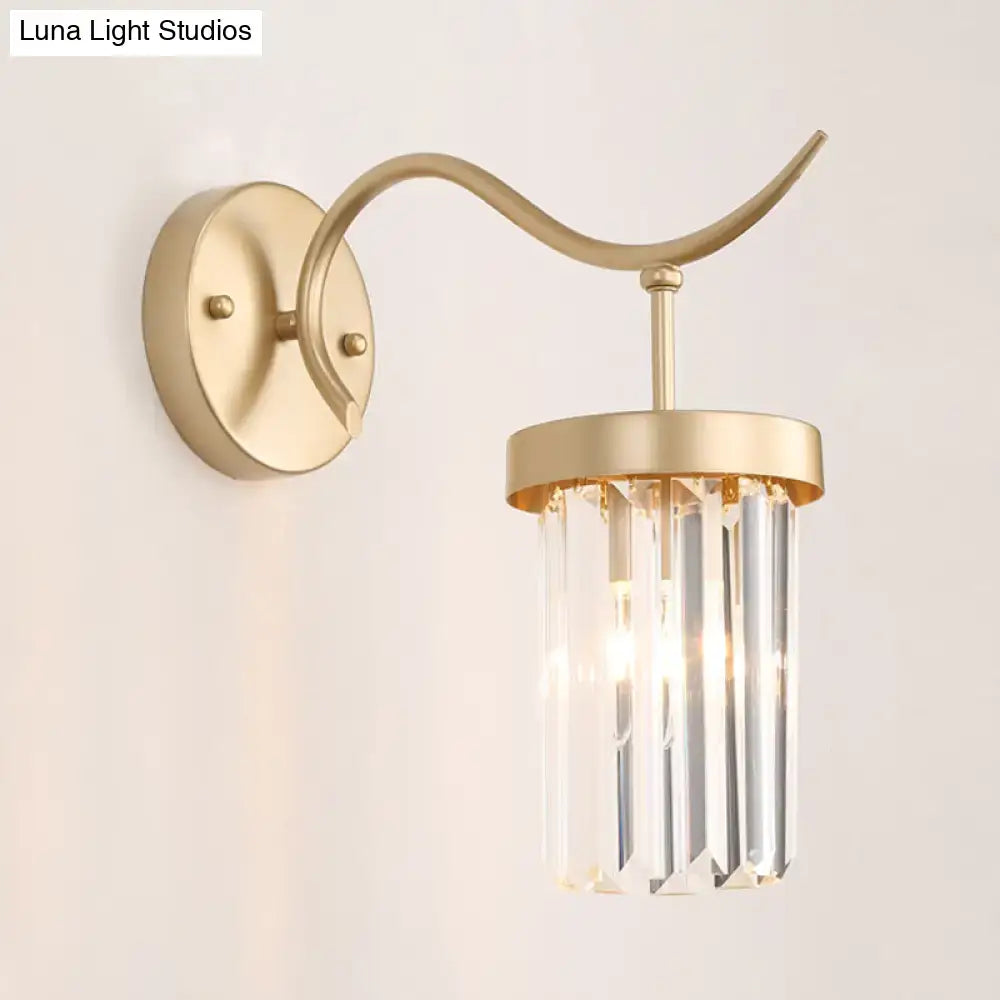 Minimalist gold-toned wall mount light with curved arm and vertical crystal prisms for bedroom sconce lighting