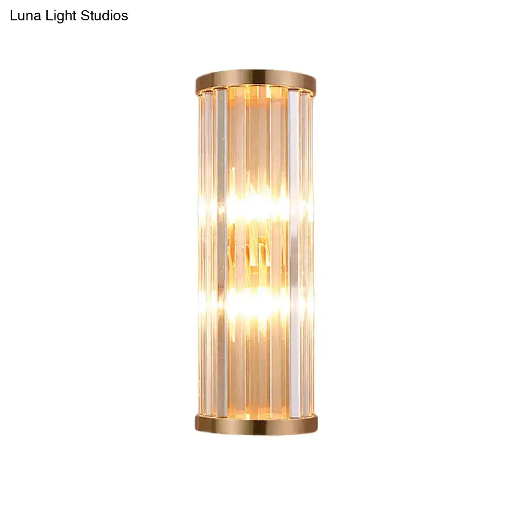 Minimalist gold crystal wall sconce with vertical rods in a metal frame emitting warm light for e12 e14 bulbs