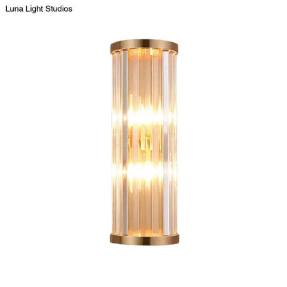 Minimalist gold crystal wall sconce with vertical rods in a metal frame emitting warm light for e12 e14 bulbs