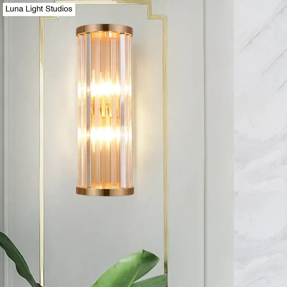 A modern minimalist gold crystal wall sconce with e12 e14 bulbs and vertical panels emitting warm ambient light