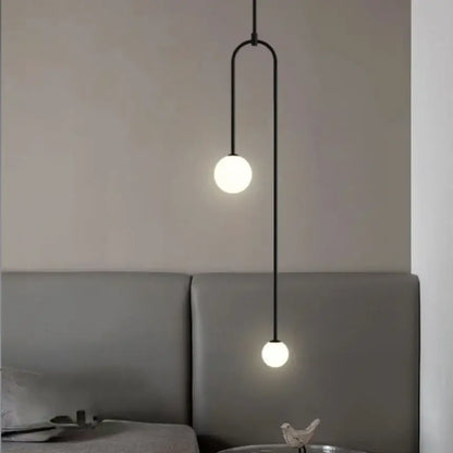 Black minimalist pendant lights with double head glass ball frosted bulbs and curved metal arm for bedroom use