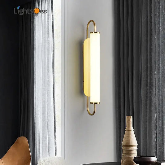 Minimalist gold elegant wall sconce with a sleek curved metal frame and frosted glass diffuser for bedroom decorbites elegant wall