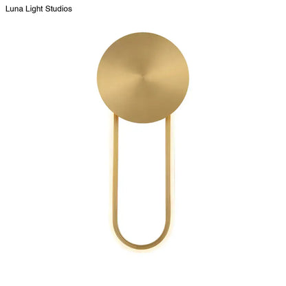 Minimalist gold elliptical wall sconce light with circular top and curved metal arms ideal for bedroom lighting