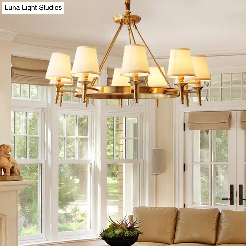 Brass minimalist conical ceiling chandelier with six cream fabric bedroom shades for elegant lighting