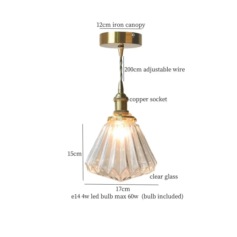A minimalist led hanging light with a clear faceted glass conical shade and brass finish for dining room use