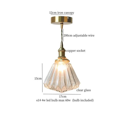 A minimalist led hanging light with a clear faceted glass conical shade and brass finish for dining room use