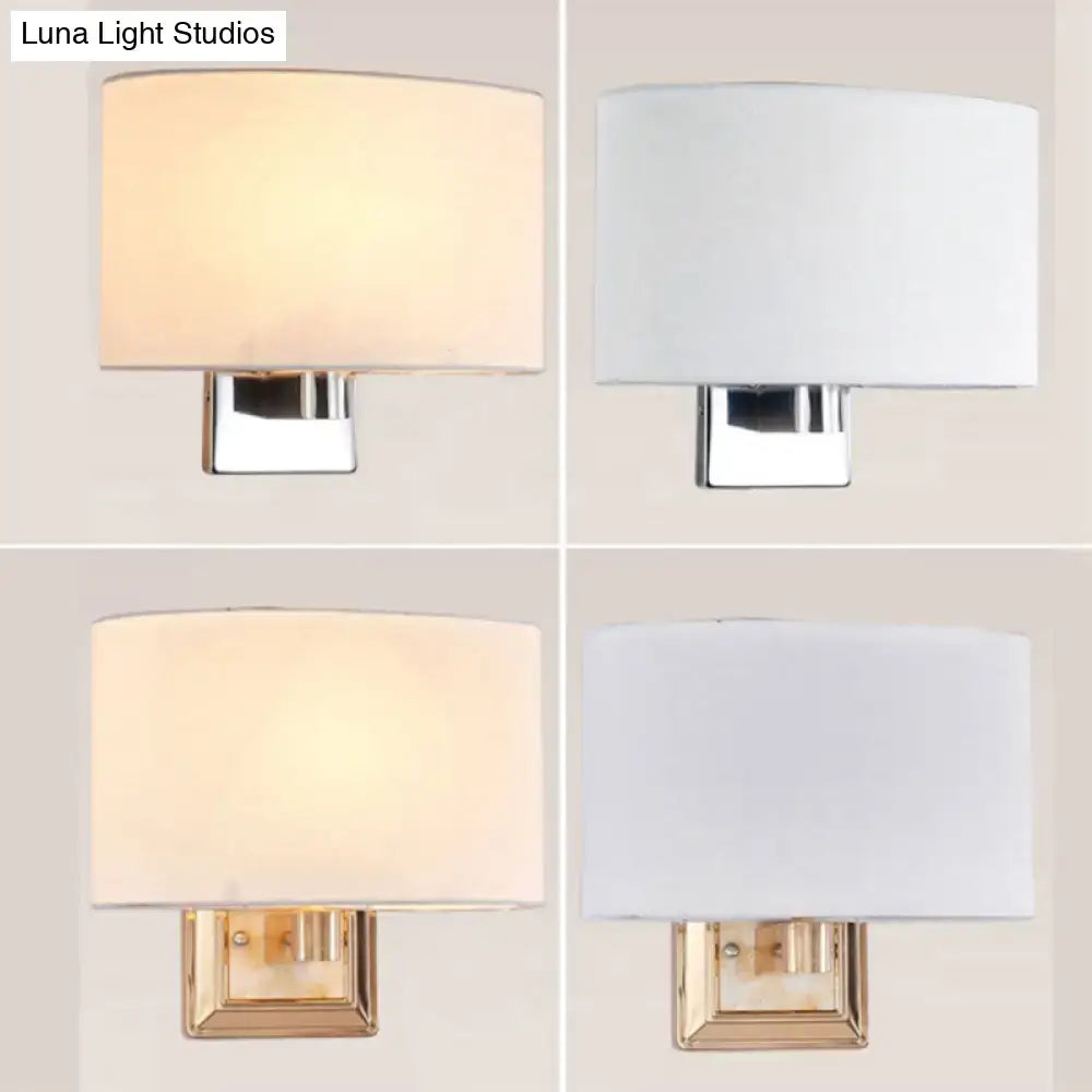 Modern rectangular wall sconce with a soft fabric shade and chrome or brass-finished metal base, available in two distinct finishes.