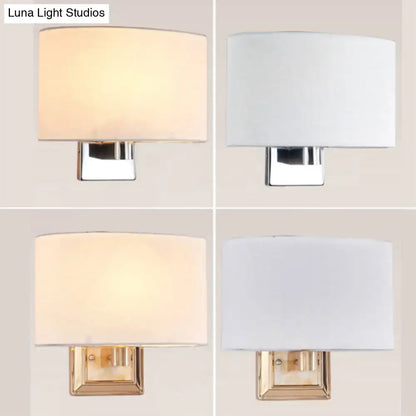 Modern rectangular wall sconce with a soft fabric shade and chrome or brass-finished metal base, available in two distinct finishes.