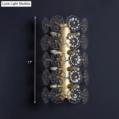 Minimalist gold floral crystal sconce light with clear flower-shaped glass elements arranged in vertical rows for bedroom