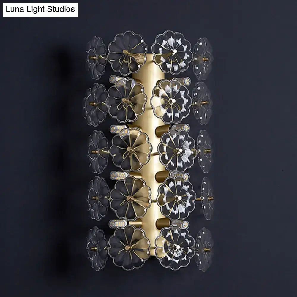 Minimalist gold floral crystal sconce light featuring gold-toned metal and clear flower-shaped glass elements for bedroom