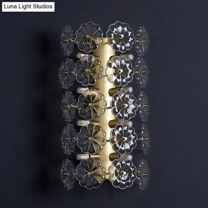 Minimalist gold floral crystal sconce light featuring gold-toned metal and clear flower-shaped glass elements for bedroom