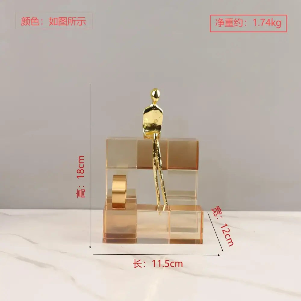 Golden metallic figurine sitting atop transparent acrylic blocks geometric stair crystal ornament for living room decorbites