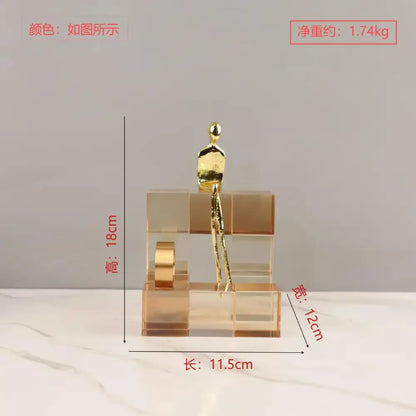 Golden metallic figurine sitting atop transparent acrylic blocks geometric stair crystal ornament for living room decorbites
