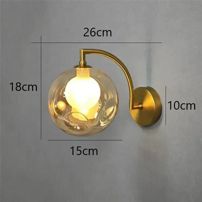 Minimalist wall sconce with a gold-toned frame and textured translucent glass ball wall lamp for bedroom lighting