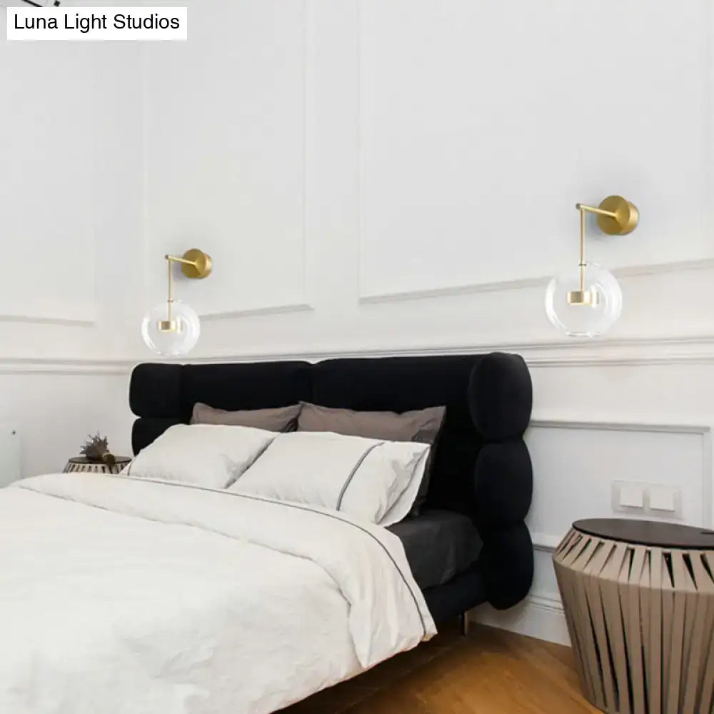Minimalist gold finished wall hanging light with clear glass globe shades for bedroom wall hanging sconce