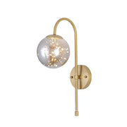 Minimalist gold wall light with gooseneck arm and smoke gray amber spherical globe containing fairy lights for bedroom