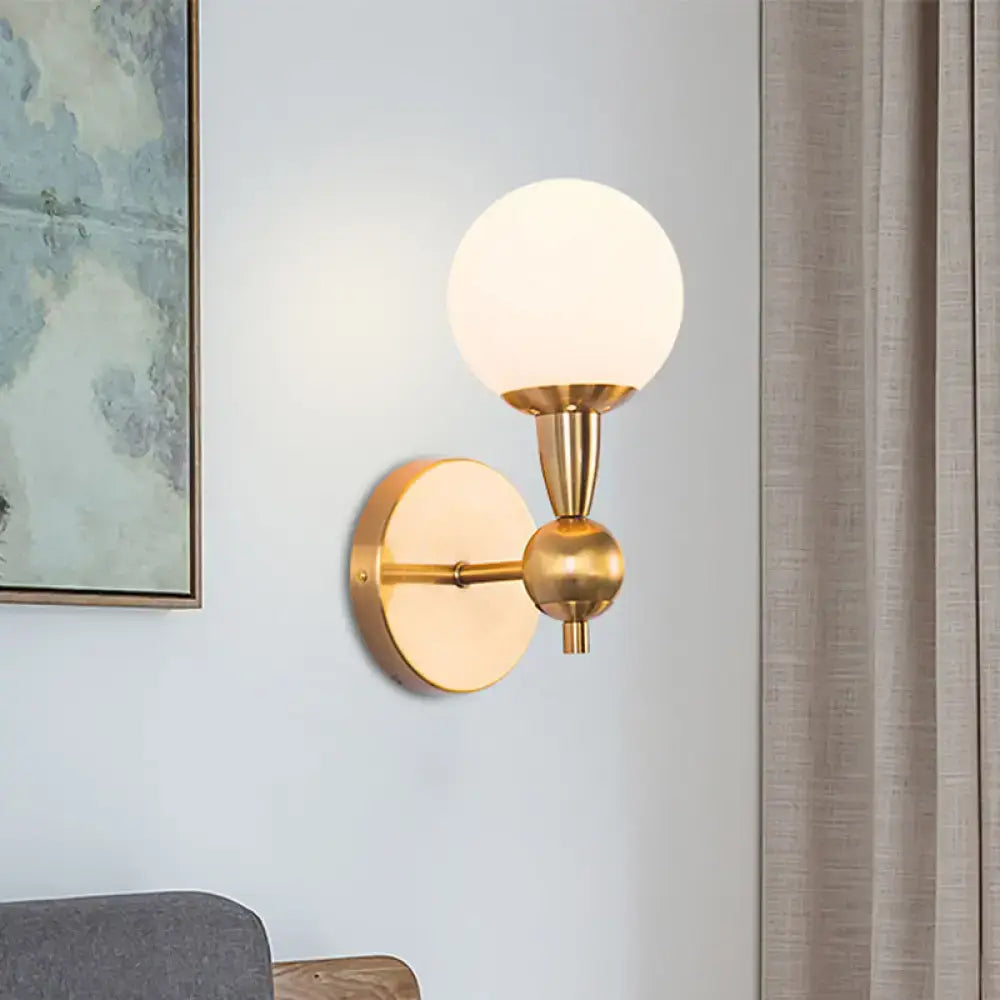 Minimalist gold wall sconce with hand blown frosted glass globe shade for elegant bedroom sconce light