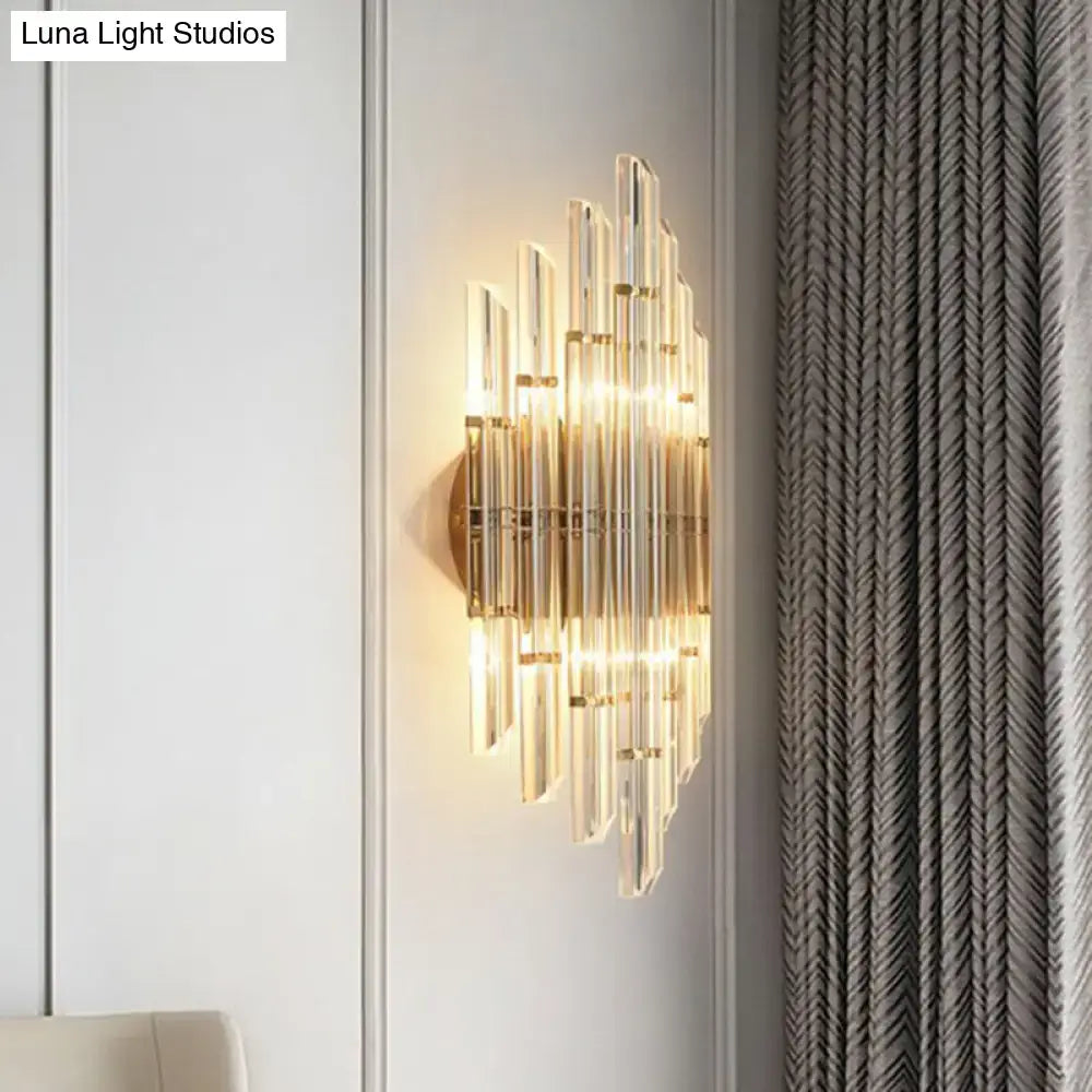 Minimalist gold k9 crystal wall sconce light with radial clear crystal rods in a sunburst pattern for living room