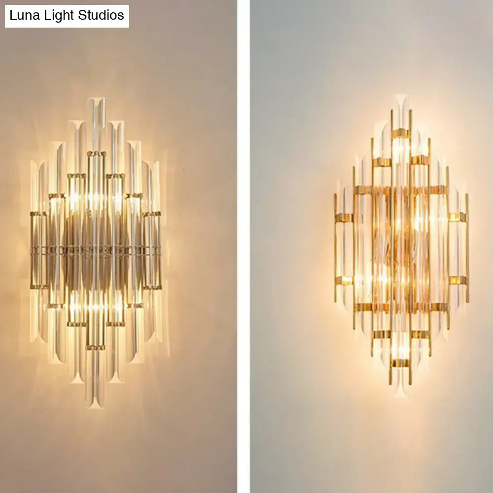 Minimalist gold k9 crystal wall sconce light with clear glass rods arranged in a symmetrical radiating pattern