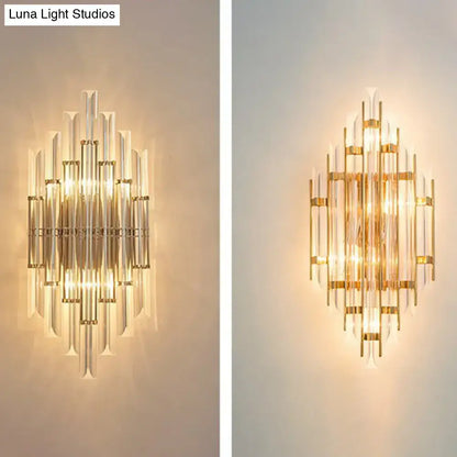Minimalist gold k9 crystal wall sconce light with clear glass rods arranged in a symmetrical radiating pattern