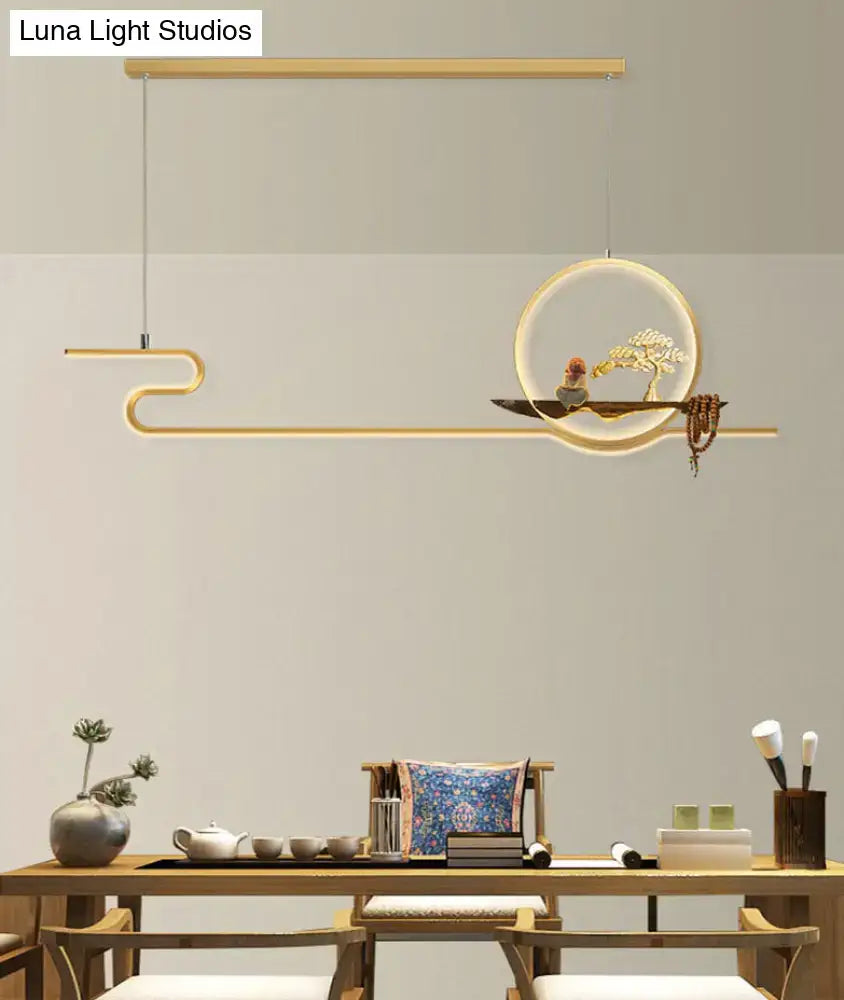 Modern gold-toned linear hanging lamp with minimalist circular frame, chain cord length, featuring bonsai tree design
