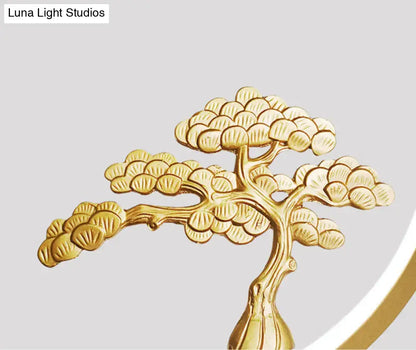 Minimalist gold metallic bonsai tree sculpture with detailed foliage and slender trunk for linear hanging lamp design