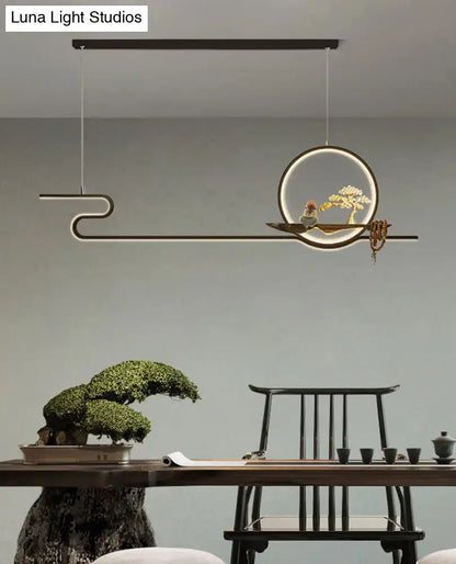 Minimalist gold linear hanging lamp with circular illuminated frame, bonsai tree, and chain cord length for study room