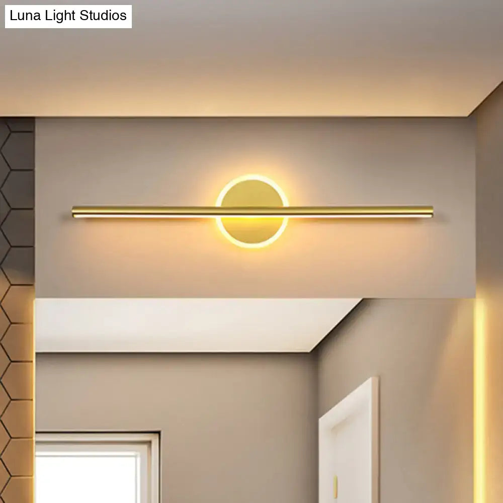 Minimalist gold linear led modern wall sconce with a sleek horizontal bar and circular illuminated center for bedroom vanity