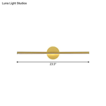 Minimalist gold linear led wall sconce with a gold-toned sleek horizontal bar and circular light fixture modern wall sconce