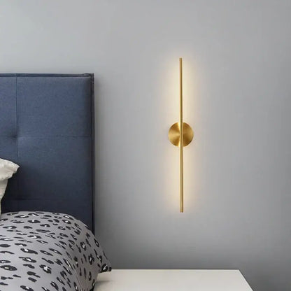 Minimalist gold linear led wall sconce lamps with gold-toned rod and base emitting soft ambient light for bathroom use