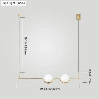 Minimalist gold metal island pendant ceiling light with two white glass spherical shades for dining table use