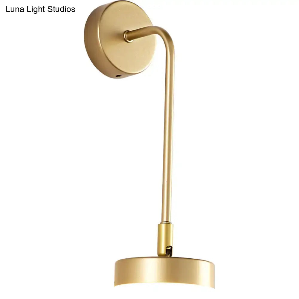 Minimalist gold metal led sconce with sleek curved arm and circular base wall mounted lamp for bedroom use