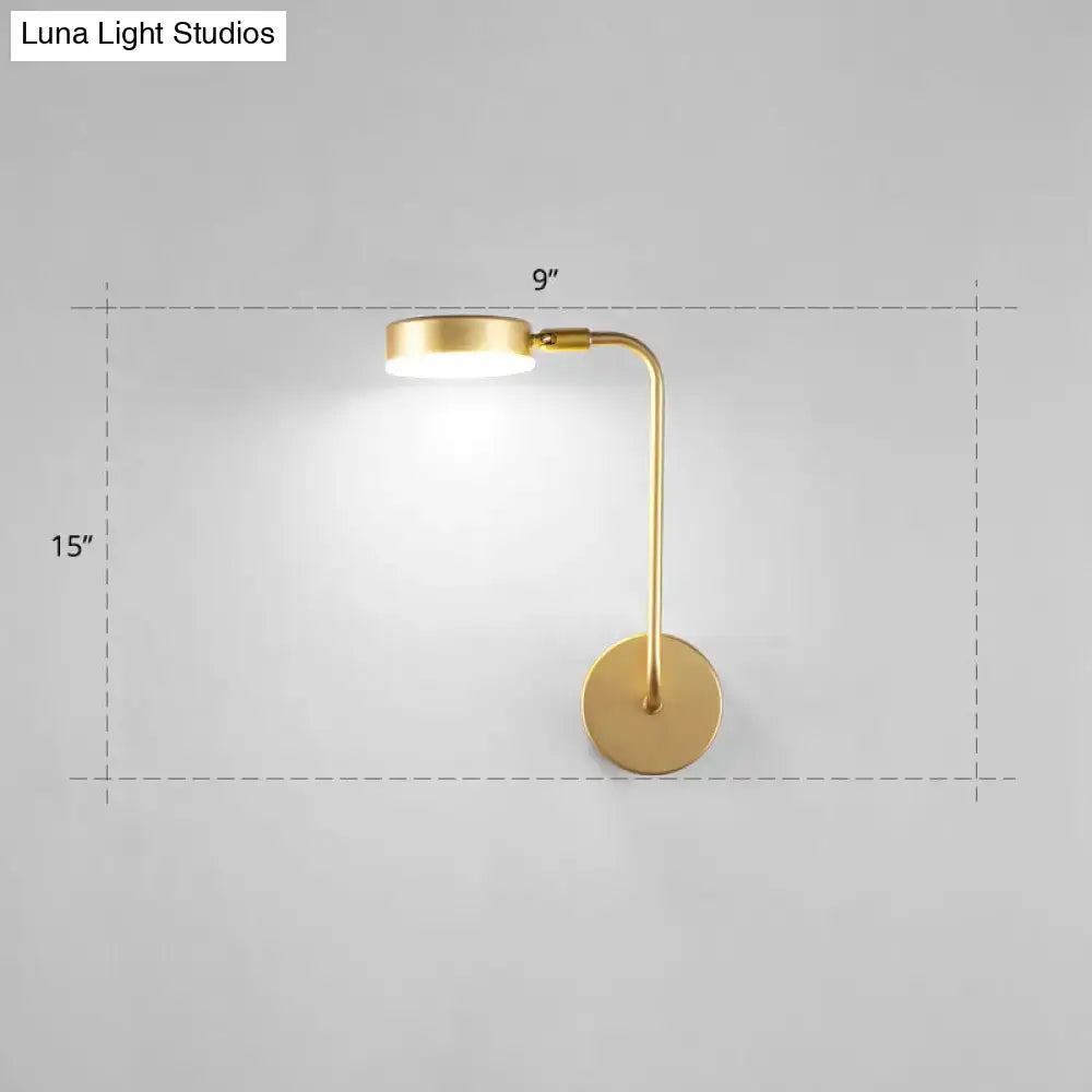 Minimalist gold metal led sconce wall mounted lamp with sleek curved arm and circular base for bedroom lighting