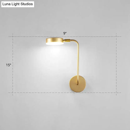 Minimalist gold metal led sconce wall mounted lamp with sleek curved arm and circular base for bedroom lighting